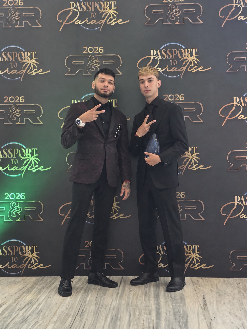 Team members at the Passport to Paradise event backdrop